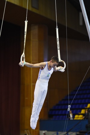 Kyiv. Ukraine-April 1, 2017 : Male gymnast performing on stationary gymnasic rings during Stella Zakharova Artistic Gymnastics Ukraine international Cupのeditorial素材