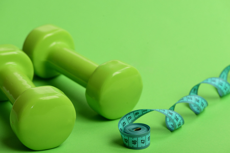 Sports equipment and cyan measuring tape in rollの写真素材