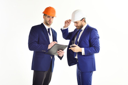 Business partners look at building plan.