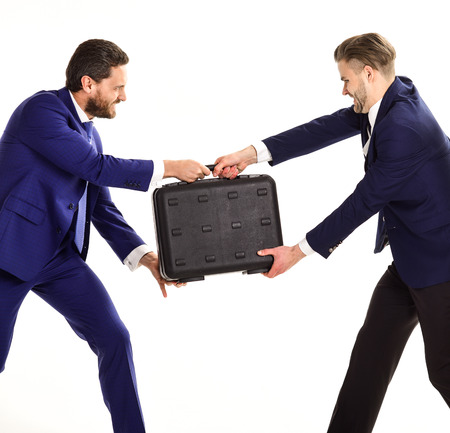 Partners with aggressive faces hold case on white background.の写真素材