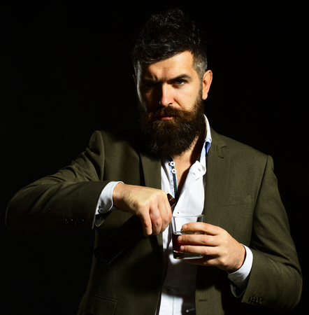 Businessman with serious face in suit on black backgroundの写真素材