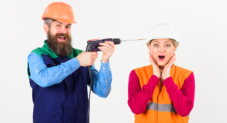 Builder, repairman makes hole in female head.の写真素材