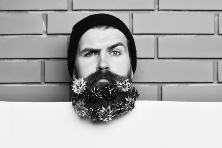 Bearded man, brutal caucasian squinting hipster with gift decoration starsの写真素材