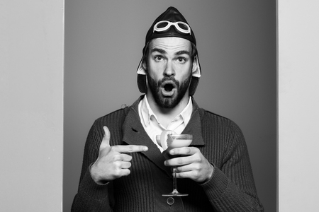 bearded pilot with cocktail in glassの写真素材