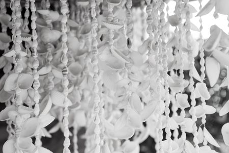 Seashell necklaces hanging for sale in Key West, USA on blurred background. Jewelry and adornment. Souvenirs, gifts and presents. Summer vacation and holiday. Travel and traveling conceptの写真素材