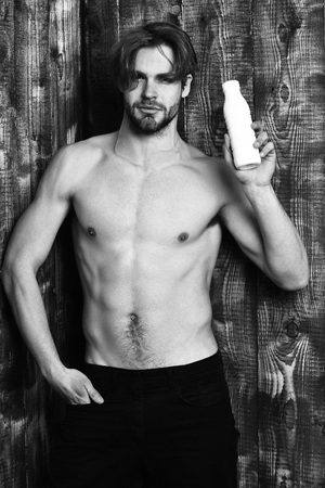 Caucasian bearded sexy macho man holding kefir or yogurtの写真素材