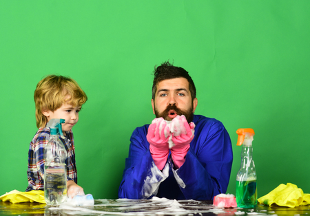 Guy with beard and mustache with gloves blowing on foam