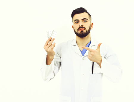 Man with concentrated face in white coat. Treatment, ambulance servicesの写真素材