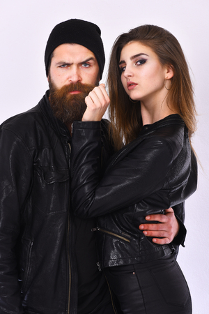 Girl and bearded man in black leather jacket and hatの写真素材