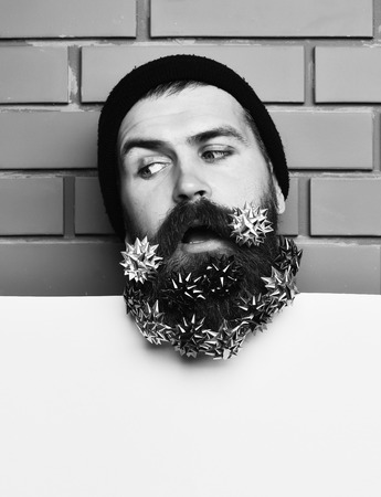 Bearded man, brutal caucasian surprised hipster with gift decoration starsの写真素材