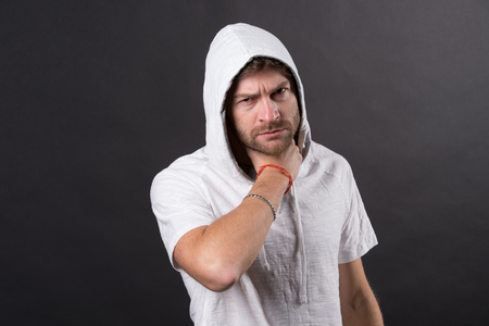 Man with beard touch neck. Bearded man with pain in throat. Fashion model wear hood of casual tshirt. Health and healthcare concept. Fashion style and trend.の写真素材