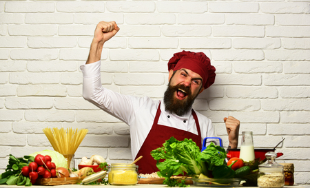 Restaurant cuisine concept. Chef prepares meal. Man with beardの写真素材