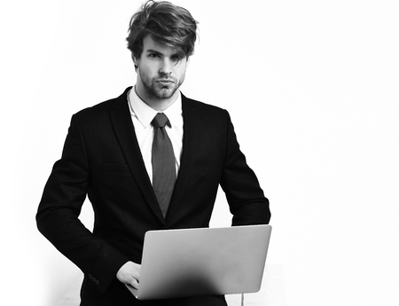 Caucasian stylish business man holding laptopの写真素材