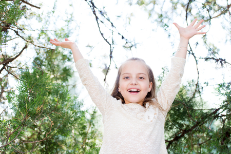 Happy girl play on fresh air outdoor. Little child smile in summer park. Fashion kid have fun on nature. Summer vacation and activity. Game with fun and active restの写真素材