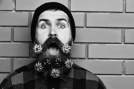 Bearded man, brutal caucasian surprised hipster with gift decoration starsの写真素材