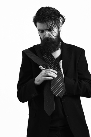 Brutal caucasian hipster in black suit with ties on shoulderの写真素材