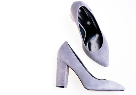 Comfortable high heels concept. Pair of fashionable high heeled shoes. Shoes made out of grey suede on white background, isolated, copy space. Footwear for women with thick high heels, top viewの写真素材