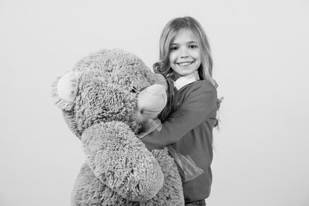 Child smile with grey soft toyの写真素材