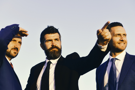 Business succsses. Man with beard and serious face points ahead.の写真素材