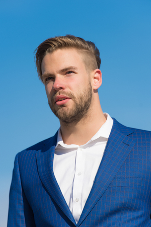 Businessman attractive appearance looks successful. Freedom concept. Businessman successful entrepreneur in suit outdoor sunny day, sky background. Man confident well groomed enjoy freedom, close upの写真素材