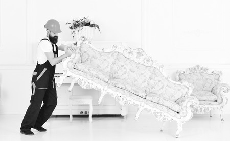 Loader moves sofa, couch. Courier delivers furniture in case of move out, relocation. Delivery service conceptの写真素材