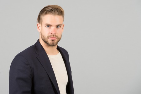 Guy bearded attractive well groomed businessman. Man with beard unshaven guy looks handsome well groomed formal wear. Fashion concept. Businessman bearded strict calm face manager, grey backgroundの写真素材