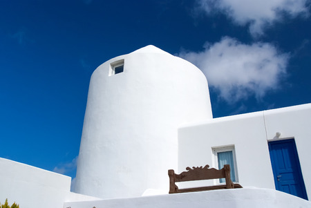 House in Mykonos, Greece. Whitewashed building on sunny blue sky. Typical house architecture and design. Summer vacation on mediterranean island. Wanderlust and travel conceptの写真素材