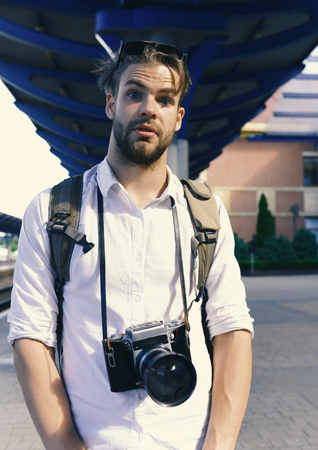 tourist on vacation. Young traveller or photographer goes sightseeing. Tourist waits on stationの写真素材