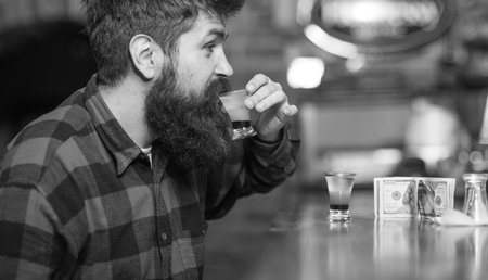 Alcohol addiction loneliness. Man with cheerful face sit alone at bar counter.