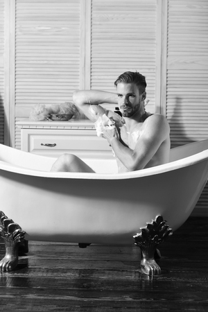Man with sexy body and peaceful face taking bathの写真素材