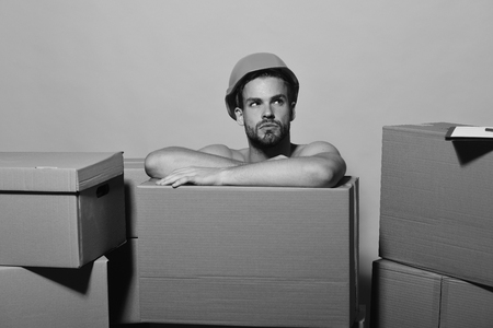 Delivery and moving concept. Guy with bare handsの写真素材