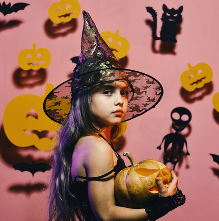celebration halloween. Little witch wearing black hat. Girl with calm faceの写真素材