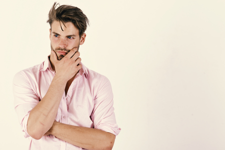 Macho rubs his chin having idea. Guy with bristleの写真素材