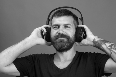 Dj music song. Singer with beard and smiling face enjoys music.の写真素材