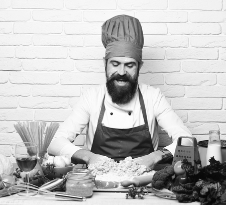 cook is cooking. Chef makes dough. Restaurant cuisine concept. Cook with happy faceの写真素材