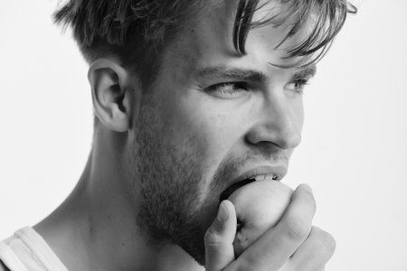 apple, diet. Athlete with messy hair eats fresh fruit. Nutrition and healthの写真素材