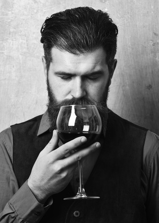 Service and catering concept. Sommelier with glass of red wineの写真素材