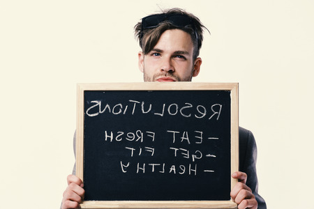 Man holds blackboard with sign pointing healthy lifestyle resolutions.の写真素材