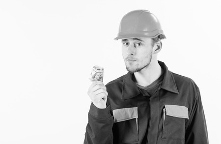 Builder earn money, repairman holds cash, banknotes in hand.の写真素材