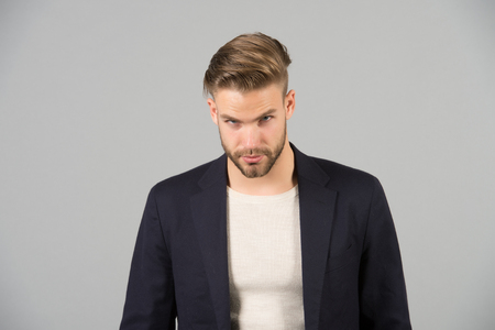 Guy bearded attractive well groomed businessman. Businessman bearded strict calm face manager, grey background. Man with beard unshaven guy looks handsome well groomed formal wear. Fashion conceptの写真素材
