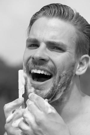 The guy is shaving. Beauty and healthcare concept: man with bristle shavingの写真素材