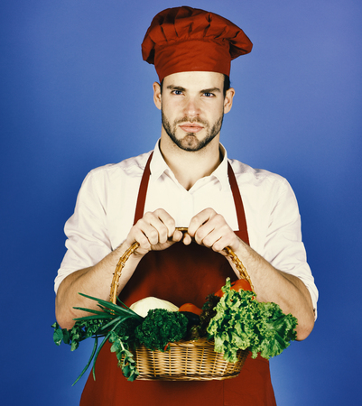 Cooking concept. Cook with beard on blue background.の写真素材