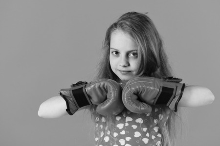 Kid pose in boxing gloves on red backgroundの写真素材