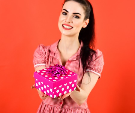 Girl with cheerful face, make up and pink box.の写真素材