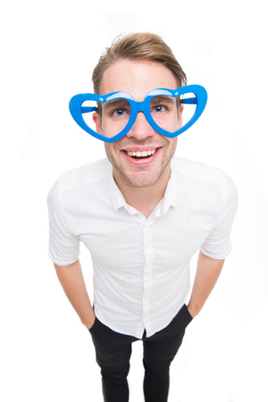 In love glance. Man happy smiling blond blue eyes in heart shaped eyeglasses fall in love. Perfect boyfriend fall in love. Man handsome attractive looks lovely and sweet isolated white backgroundの写真素材