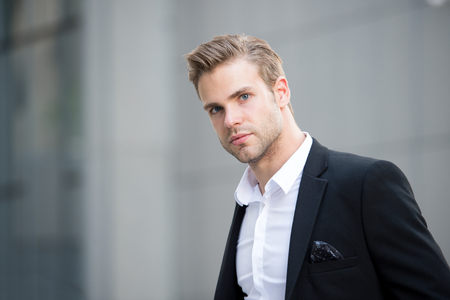 Businessman on the go. Guy handsome attractive office worker go meeting. Man well groomed elegant formal suit walks urban background. Businessman serious quick walk during lunch timeの写真素材