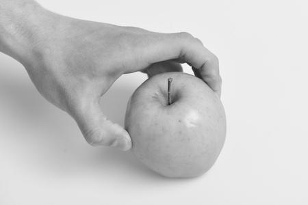 Vitamins and fitness concept. Male hand touches light green apple.の写真素材