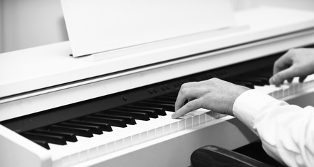 Live music concept. Music performers hands with white cuffs playing piano.の写真素材