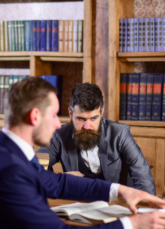Men in suits, oldfashioned professors, scientists in library with books