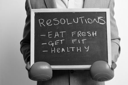 Eat fresh, get fit and health concept. Man in red boxing gloves on white background.の写真素材